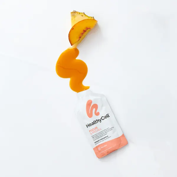 The pale orange gel from one pouch of HealthyCell Focus & Recall poured into a small glass